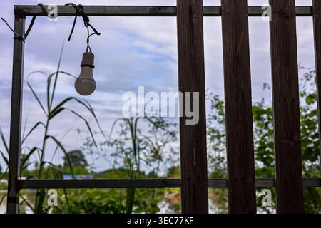 Wooden Sun Blocking Fence Wall, A clean photo of wooden sun blocking, tall slats casting long striped shadows in warm afternoon, perfect for garden pr Stock Photo