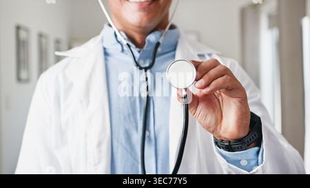 Friendly Doctor With Stethoscope Examining Patient in Clinic Held Toward Camera For Healthcare Consultation Stock Photo
