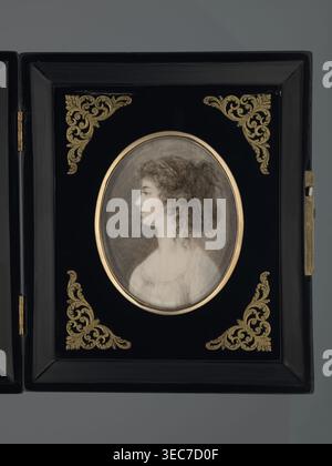 Profile portrait of Julia, née Princess Lubomirska, Countess Potocka; creator, profile female portrait showing hairstyle; miniature height 7.3 cm, width 5.8 cm; dated 1780; Poland Krzeszowice, Lesser Poland Voivodeship; Polish miniature; references Potocki, Andrzej Stefan; repossession provenance., A framed oval portrait of a woman in profile is set within a rectangular black frame decorated with ornate corner motifs; the portrait shows a pale-skinned woman with curly brown hair pulled back, wearing a light-colored garment, and the oval is bordered by a thin metallic ring. The black frame Stock Photo