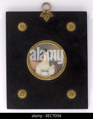 Portrait of a woman reading a book, unknown author amateur; books; woman; full-face portrait; interior; female portrait; hairstyle; Polish miniature; amateur; 1825; miniature, A rectangular black plaque with a glossy finish features a central round miniature portrait set in a decorative gold frame; the portrait shows a person with curly dark brown hair wearing a white dress with a blue sash and holding a small blue-gray object, seated against a muted background of soft gray and brown tones. The plaque is embellished with several ornate gold floral or sunburst motifs near the corners and a gold Stock Photo