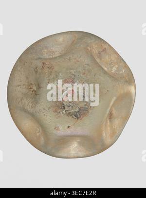Flask, unknown eastern workshop, 3rd–4th century AD, vessel, height 11 cm, A rounded, irregularly shaped object with a lumpy, dented surface showing a mix of muted greens, pale beige, tan, and sandy browns, with areas of darker brown and rusty orange mottling. The surface has patches of rough, pitted texture and smoother, slightly glossy areas, with a central region that contains a mix of speckled discoloration in gray, brown, and dull red, and subtle iridescent sheen in places. The background is a uniform light gray. Stock Photo