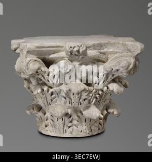Corinthian capital, Sacred/Roman architecture; architectural element and decorative capital, 2nd century, Roman Empire 27 BC–476. Corinthian similar to kalathos capital with three rows of acanthus leaves; all leaves similar, wavy surfaces, divided by deep, softly bending grooves veins to the sides, rounded with lobed edges. Upper edge of the kalathos visible above the leaves. Abacus with extended corners composed of two plates of almost equal height. Round hole on the upper surface probably trace of contemporary mounting and a similar hole in the base. Great softness of modeling of details; Stock Photo