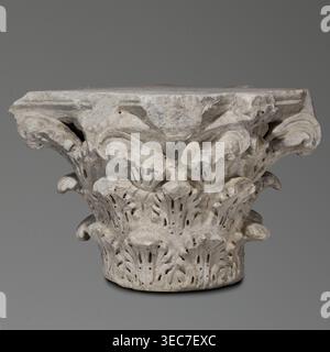 Corinthian capital, Sacred architecture, Roman architecture; capitals; acanthus ornament; rosettes. Corinthian capital similar to kalathos capitals. 3 rows of leaves. All leaves similar, with a wavy surface, divided by deep, softly bending grooves—veins—to the sides, rounded, with edges divided into lobes. The upper edge of the kalathos is visible above the leaves. An abacus with extended corners is composed of two plates of almost equal height. A round hole on the upper surface of the capital—probably a trace of contemporary mounting of the capital. A similar hole in the base. Great softness Stock Photo