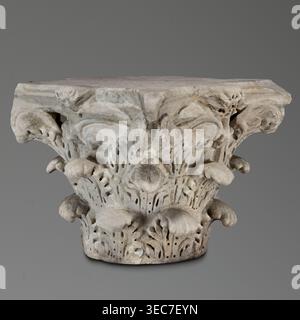 Corinthian capital, Sacred and Roman architecture; Corinthian capital similar to kalathos capitals. 2nd century, Roman Empire 27 BC–476., Materials and form: 3 rows of acanthus leaves, all similar with wavy surfaces, divided by deep, softly bending grooves veins to the sides; leaves rounded with edges divided into lobes. The upper edge of the kalathos is visible above the leaves. An abacus with extended corners composed of two plates of almost equal height. A round hole on the upper surface of the capital—probably a trace of contemporary mounting; a similar hole in the base. Great softness of Stock Photo