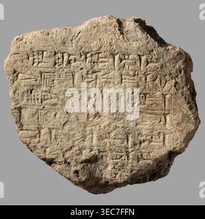Fragment of a brick with a cuneiform inscription, Nebuchadnezzar II reign 604–562 BC, impressed with a stamp, bearing 7 lines of cuneiform commemorative text of the Babylonian king Nebuchadnezzar II Neo-Babylonian period. From Esagila Babylon / Ezida Babylon; possibly found at Borsippa, Iraq. Architectural brick, Near Eastern architecture; cuneiform writing. Material: brick with layer of bitumen. Weight: 1.6 kg. Dimensions: length max 17 cm; width 15.5 cm; thickness 7 cm brick only, 8 cm with bitumen., A roughly circular flat stone tablet with irregular edges resting against a neutral gray Stock Photo