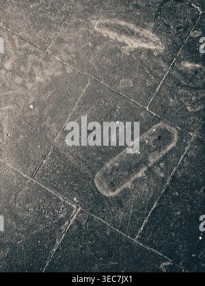 Dark grunge scratched textured surface vertical photo featuring rough distressed stone or concrete material with aged weathered details. Perfect for b Stock Photo
