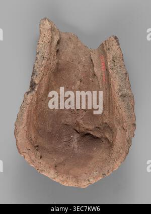 Votive offering in the form of a womb;, votive offering, body part ex-voto in the form of a womb; 332–30 BC, Hellenistic period; Caere place of origin; terracotta, ; height 4.5 cm, length 13.2 cm, width 9 cm, weight 0.27 kg., A roughly oval, broken clay object with uneven, craggy edges and a concave interior, showing a textured, gritty surface in shades of reddish-brown and tan with small darker specks; the piece has irregular raised rims on two sides and an area of rougher, more weathered outer surface, all set against a flat gray background. Stock Photo