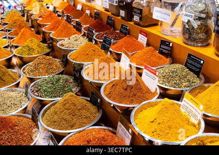 Bowls of spices, herbs, and teas displayed in a market stall, colorful piles of spice for sale Stock Photo