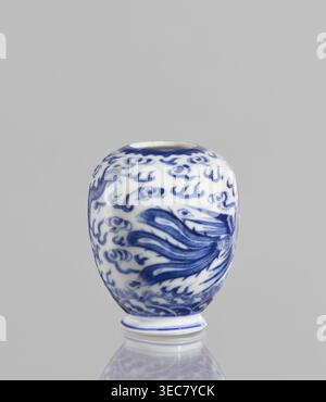 Vase, ceramics, blue and white porcelain, decorated with phoenixes, dragons and clouds; Chinese, Qianlong style, 19th century, China; vessel; height 7.5 cm, diameter 2.5 cm., A small rounded ceramic vessel sits on a reflective surface against a plain light gray background, the vessel glazed in white with an intricate blue painted design of flowing, wave-like motifs and curling cloud-like shapes covering its curved body, a few darker blue brushstrokes suggesting feathery or fin-like forms, a narrow circular opening at the top rim edged in blue, and a short foot with a blue band at the base; Stock Photo