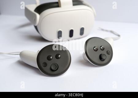 Modern virtual reality headset with controllers placed on white background, technology concept for gaming, simulation and immersive experience. Stock Photo