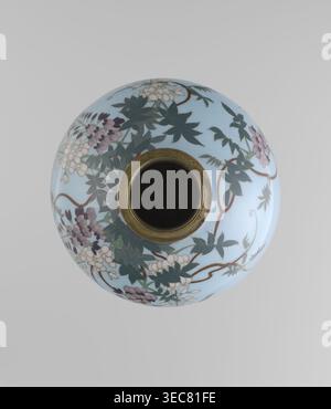 Vase, Gonda Hirosuke 1865–1937 author, Japanese, Meiji 1868–1912. Small spherical cloisonné enamel vase, one of a pair, on a low ring foot and a round ring spout, both set in silver-plated metal. Decorated with a realistic, colorful motif of red veil fish beneath hanging wisteria leaves and flowers on a light blue background. The bottom bears a maker’s mark in the form of a flaming pearl with the katakana character コ ko, the mark of enameller Gonda Hirosuke of Nagoya. Circa 1890–1910. Height 9.0 cm; diameter 8.2 cm., A round ceramic vessel photographed from above with a light blue surface Stock Photo
