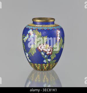 Vase, cloisonné enamel, Chinese, oval-shaped with a short neck and ring-shaped spout, without a foot; decorated on the central belly with colorful peonies on a sapphire background and a Chinese meander motif; 19th century Qing, 1644–1911; height 16.5 cm, diameter 13.8 cm; maker, provenance unknown., A rounded vase with a narrow neck and a metallic rim sits against a plain gray background, its surface predominantly bright blue with an intricate darker blue geometric pattern. The body is decorated with floral motifs in green leaves and blossoms showing white, pink, red, and yellow tones, with Stock Photo