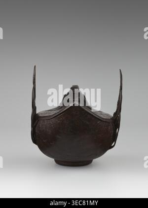 Duck incense burner, Chinese, Qing 1644–1911, 19th century, porcelain vessel in form of ducks with wings, function: incense burner, height 9.7 cm, width 13.6 cm, subject: ducks birds., An object resembling a dark brown, rounded metal vessel with a raised rim and a pointed front edge, flanked by two thin vertical extensions on either side; the surface appears uneven and textured with darker and lighter brown variations, and the background is a smooth gradient of gray transitioning from a darker gray at the top to a lighter gray near the bottom. Stock Photo