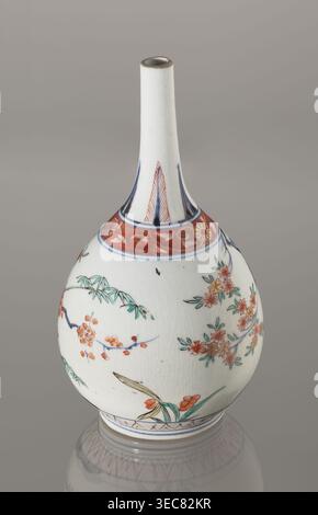 Bottle, decorated in the kakiemon style with a motif of the three friends of winter bamboo, plum, and pine; rock. Also decorated with two borders with plant motifs and floral patterns on the neck. Early 18th century, Edo period 1603–1868, Japan. Porcelain vessel sake bottle, height 22.1 cm, diameter 12 cm. Materials: ceramics, porcelain. Subjects/ornament: bamboos, pines, plums, plant ornament, Imari influence., A ceramic bottle with a long narrow neck and rounded body sits against a neutral gray background, decorated with painted floral and bamboo motifs in colors including white, red, green, Stock Photo