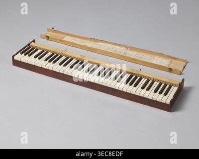 Harmonium, Jacob Deutschmann 1795–1853, 1822–1830. Fisharmonia veneered with mahogany, with a sliding mechanism and keyboard placed in an elongated rectangular case supported by two stringer legs; signed on the inside of the keyboard cover J. DEUTSCHMANN / IN WIEN brass sheet inlay. The legs and suspended pedal support lyre are in the shape of elongated vases. Forged openwork steel pedals. The keyboard table slides forward. Bone knobs on the upper part of the short sides lock the inner casing. Keyboard cover locks with a latch and braided hinges so-called piano. Biedermeier style. Vienna. Stock Photo