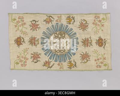 Antependium, antependium; fragment of church embroidery on cream silk satin 46 gauge, green selvedges with embroidery and glued appliqué of colorful silk threads, gold and silver threads, and sequins. In the center, a large radiant medallion bears the IHS monogram with a cross and three nails. Background filled with projections of stylized floral sprigs; small sprigs in the corners and on the sides of the medallion are embroidered, remaining background motifs are appliquéd glued. 18th century, Poland; fabric; height 82 cm, width 47 cm., A rectangular piece of fabric with a light beige Stock Photo
