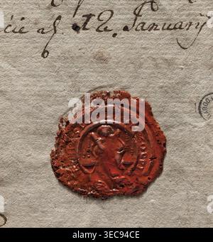 Round wax impression of the seal of the town of Przemęt. In the central field, the figure of Saint Andrew sitting on a throne. In his right hand he holds a diagonal cross. Around the rim is the inscription: SIGILLUM OPPID[?]. Dated 1785. Poland. Stamp., A close-up view of a textured, beige paper surface with a worn red wax seal pressed onto it; the wax seal is irregularly shaped with rough, cracked edges and a glossy, slightly uneven finish, showing an embossed central figure with curved lines and circular borders; the paper shows visible fibrous texture and subtle creases, with small dark Stock Photo