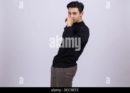 Young man posing thoughtfully while looking at the camera Stock Photo