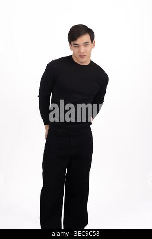 Man in black clothes looking thoughtfully at camera Stock Photo