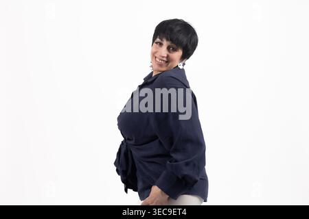 Mature woman posing in dark blue shirt and white skirt Stock Photo