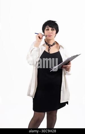 Businesswoman in white shirt and glasses using a tablet Stock Photo