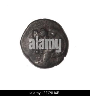 bronze coin, Pantikapaion, Dioscuri caps (iconographic), Satyr's head (iconographic), Black Sea, cornucopia (iconographic), Satyr (mythology), Dioscuri (mythology), ob: head of bearded Satyr in ivy wreath facing left; obverse: cornucopia, Dioscuri caps topped with stars on the sides, inscription below them; 4th quarter of the 2nd century BC, Cimmerian Bosporus, Pantikapaion, coin, weight 4.60 g, axis 330 degrees, dimension 1 17 mm, dimension 2 16.5 mm, A round, worn object with an uneven, textured surface in dark brown and black tones sits against a white background; the object shows raised, Stock Photo