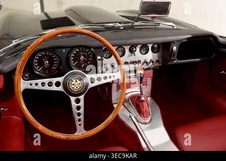 E-Type Jaguar sports car with red leather interior and wooden steering wheel. Stock Photo