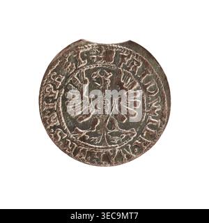 Crown groschen; maker: Baltazar Stanisławski (1609–1614); ruler: Sigismund III Vasa (King of Poland; r. 1587–1632); date: 1610; place: Kraków, Poland; object: coin; weight: 1.57 g, A round metallic object with a worn, textured surface showing a raised central motif resembling a symmetrical bird with outstretched wings, surrounded by a raised circular border and decorative elements; the metal displays a mix of brown, dark brown, and muted greenish patina with lighter highlights on the raised areas, and the edges show slight irregularities and wear. Stock Photo