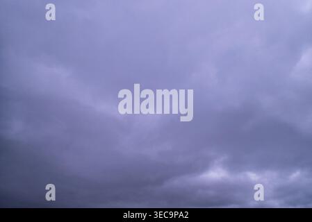 Purple and grey moody sky with thick cloud cover Stock Photo