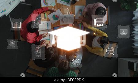 A diverse group of professionals collaborates on a business strategy, surrounded by digital educational icons, showcasing innovation and teamwork in a Stock Photo