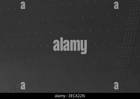 Texture suggests industrial use or mechanical construction. Each rivet aligned in straight rows creates structured grid Stock Photo