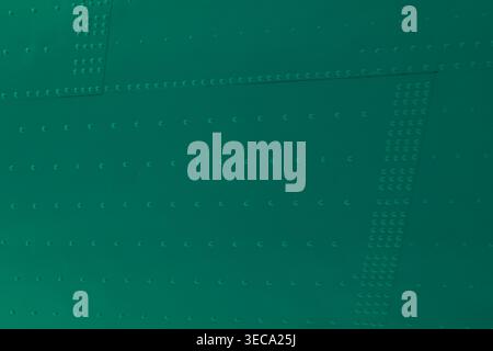 Even rows of small rivets and bolts create a structured design. Clean lines and a smooth texture suggest industrial use. Stock Photo