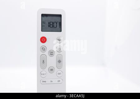 Air Conditioner Remote Control Set to 18°C on White Background with Copy Space, Summer Cooling Concept Stock Photo