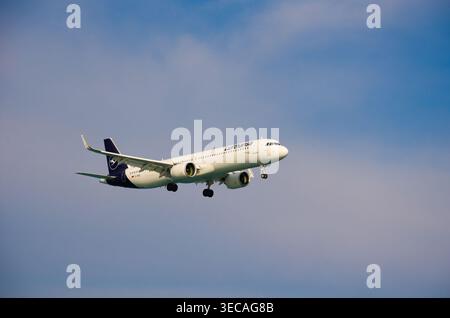 Commercial Airplane Flying in Clear Sky Stock Photo