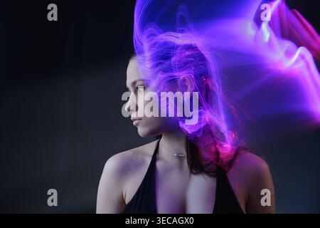 Portrait with purple light effects illustrating artificial intelligence, neural activity, and mental processing. Stock Photo