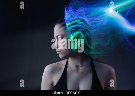 Portrait with multicolor light trails representing artificial intelligence, neural signals, and data processing. Stock Photo