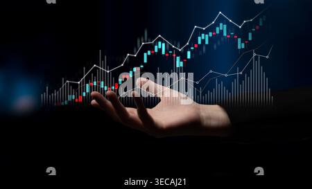 A hand reaches out towards a financial chart depicting an upward trend and dynamic analytics, symbolizing growth and opportunity in the investment mar Stock Photo