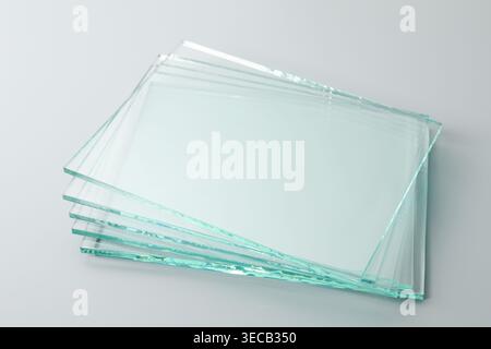Stack of glass sheets on light grey background, closeup Stock Photo
