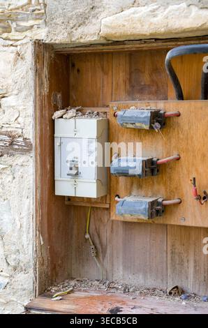 Old Electrical Fuse Box in Rustic Wall Stock Photo