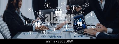 A dynamic business team engages in collaboration using technology in a modern office setting, emphasizing data analysis and effective communication st Stock Photo