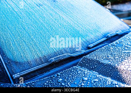 Frozen Car Windshield Completely Covered In Thick Ice And Snow During Winter Blizzard Conditions Stock Photo