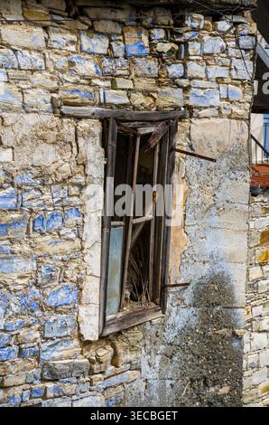 Old Broken Window in Weathered Stone Wall Stock Photo