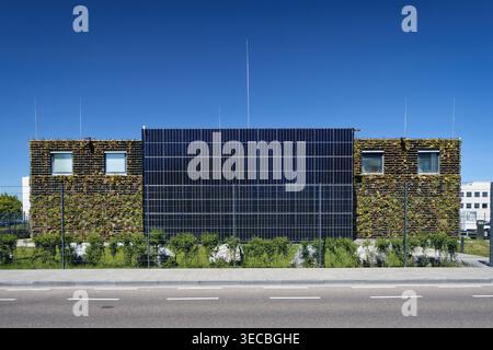 Cologne, Germany April 29 2026: The NetCologne data center in Cologne-Lövenich (built 2024), featuring a photovoltaic facade and vertical greening for Stock Photo
