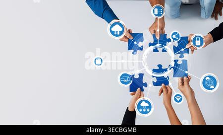 This image captures the essence of collaboration in computing, showcasing diverse hands assembling puzzle pieces with cloud technology icons in a mode Stock Photo