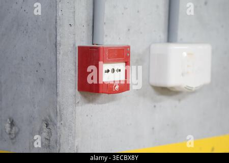 Fire alarm box is mounted on a wall in a building Stock Photo