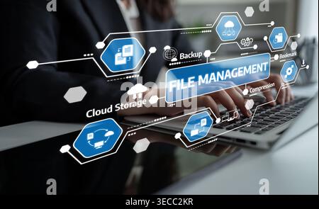 A business professional works on a laptop in a modern office, focusing on file management and utilizing cloud storage icons to enhance productivity an Stock Photo