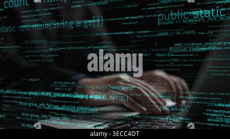 A close-up of hands typing on a laptop with programming code appearing in a neon glow, creating a futuristic atmosphere that emphasizes technology and Stock Photo