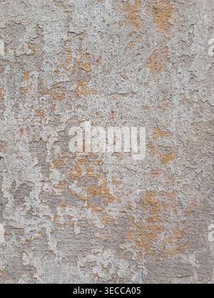 Old concrete wall, damaged, uneven structure, with remnants of yellow paint, vintage background for design Stock Photo