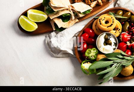 Lebanese meze or Arabic mezeler appetizers on a light background. Assorted meze and dips. Top view. Stock Photo