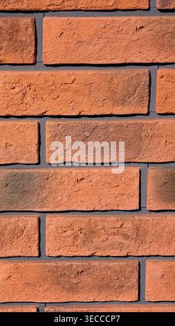 Brick wall texture with detailed red brown bricks, gray mortar and realistic surface imperfections. Ultra high resolution 8K wallpaper background Stock Photo